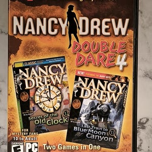May include: A Nancy Drew "Double Dare 4" PC CD-ROM game case. The case features the text "2 Award-Winning Mysteries!" and "Two Games in One for Twice the Fun." The game includes "Secret of the Old Clock" and "Last Train to Blue Moon Canyon."