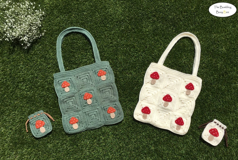 May include: Two crochet tote bags and a small pouch, all decorated with mushroom appliqu&eacute;s. One bag is teal, the other is off-white. The pouch and bags have a square pattern. The mushrooms have red caps and tan stems. The Bumble Bee logo is in the upper right corner.