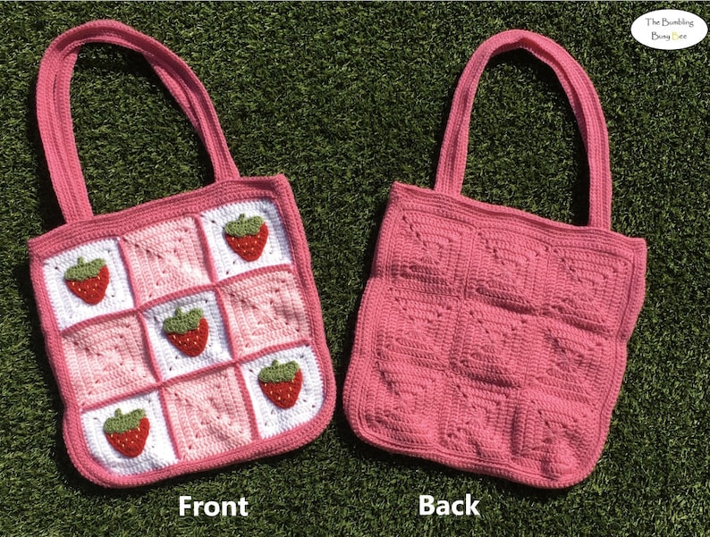 May include: A pink crocheted tote bag with a strawberry pattern on the front. The back of the bag is plain pink.