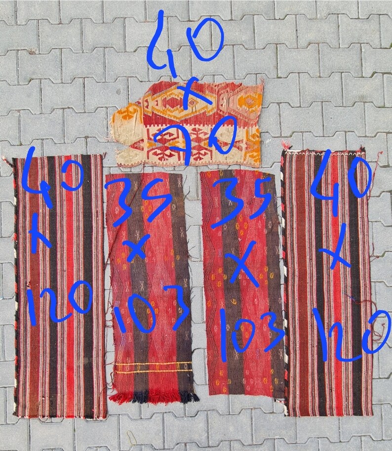 May include: Four vintage Turkish kilim rugs in red, black, and white with geometric patterns. The rugs are different sizes, with the largest measuring 40 inches by 90 inches.