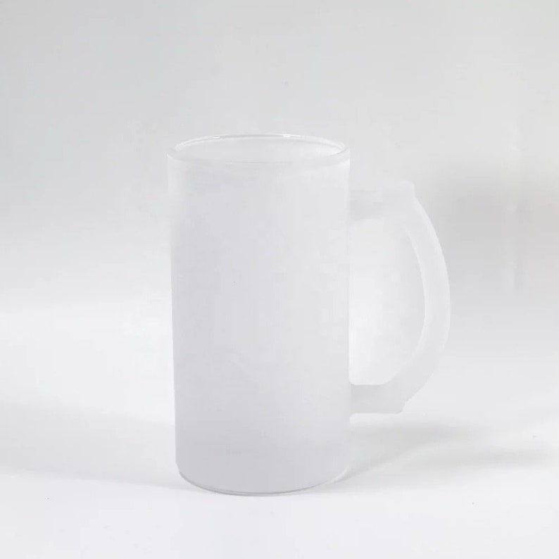 May include: A frosted glass beer mug with a handle. The mug is white and opaque.