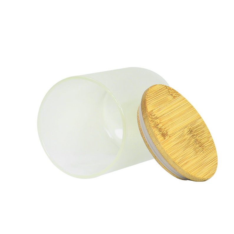 May include: A frosted glass jar with a bamboo lid. The lid is slightly ajar, revealing the clear interior of the jar.