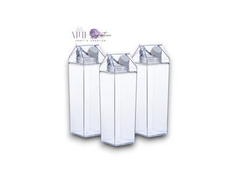 May include: Three clear plastic milk carton shaped water bottles with white lids.