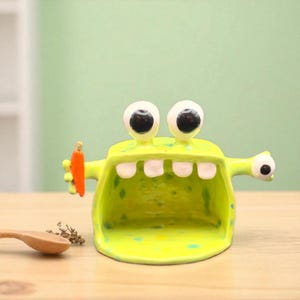 Green Monster Spoon Rest | Handmade Ceramic Creature Holding Eyeball – Quirky Kitchen Art, Spooky Halloween Gift & Unique Pottery Decor
