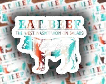May include: A sticker with a vintage-style illustration of a cow and the text "EAT BEEF THE WEST WASN'T WON ON SALADS".