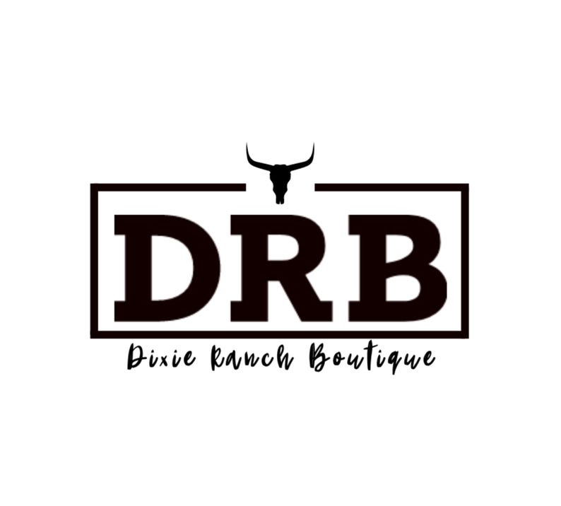 May include: A black and white logo for Dixie Ranch Boutique. The logo features the letters "DRB" in a bold, blocky font, enclosed within a rectangular frame. Above the letters is a silhouette of a bull's head. Below the letters is the text "Dixie Ranch Boutique" in a script font.