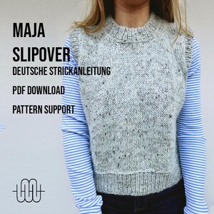 May include: A close-up of a woman wearing a grey knitted sleeveless sweater vest with a speckled pattern. The text "MAJA SLIPOVER DEUTSCHE STRICKANLEITUNG PDF DOWNLOAD PATTERN SUPPORT" is visible in the image.