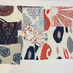 May include: Assortment of fabric swatches in various patterns and colors, including red, blue, and white. The fabrics feature paisley, floral, and geometric designs.