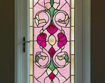 May include: A white door with a stained glass window featuring a pink and green floral design. The design includes a diamond shape in the center and a pink flower on each side.