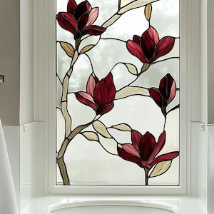 May include: A rectangular stained glass window panel featuring a botanical design of deep red magnolia flowers with light beige leaves and branches set against a translucent, frosted glass background within a white frame.