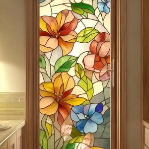 May include: A stained glass door featuring a floral design with orange, yellow, pink, and blue flowers, and green leaves. The door is framed in a light brown wood and has a silver handle.