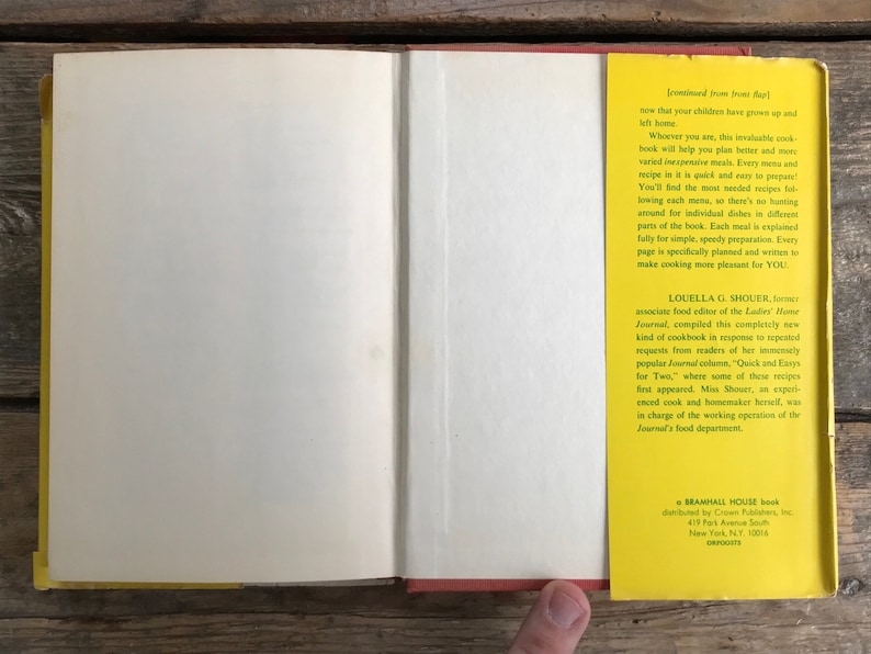 May include: A yellow and red book with the title "Quick and Easy Recipes for Two" by Louella G. Shouer, associate food editor of the Ladies Home Journal. The book is published by Bramhall House, distributed by Crown Publishers, Inc. 417 Park Avenue South, New York, NY 10016.