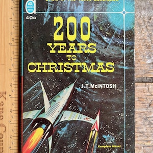 May include: Vintage paperback book cover titled "200 Years to Christmas" by J.T. McIntosh. The cover features a retro sci-fi illustration of a spaceship with a fiery exhaust against a starry background. The book is an Ace Double Novel.
