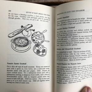 May include: A vintage cookbook page with illustrations of tomato oyster cocktail, shrimp and grapefruit cocktail, and avocado shrimp cocktail. The page includes recipes for each cocktail.