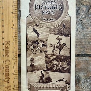 May include: A vintage National Geographic Society brochure measuring 12 inches in length, featuring a globe logo, various black and white historical photographs, and text including Nature, Books, Pictures, Maps, Travel, and Washington, D.C.