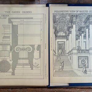 May include: An open book displaying two architectural plates. The left page, titled The Greek Orders, shows technical diagrams of the Ionic Order. The right page, titled Perspective View of Vaulted Staircase, features a detailed line drawing.