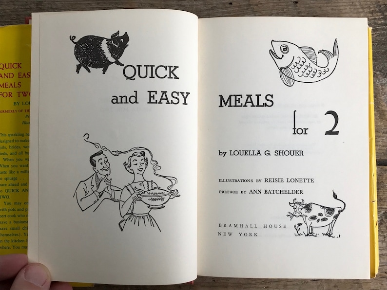 May include: A vintage cookbook titled "Quick and Easy Meals for 2" by Louella G. Shouer. The cover features illustrations of a pig, a fish, and a cow.