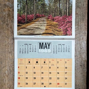 May include: Vintage 1969 calendar featuring a scenic photo of Georgia Pines near Swainsboro, Georgia. The calendar displays the month of May with a spiral binding. The bottom includes the business information for M.E. Potter.