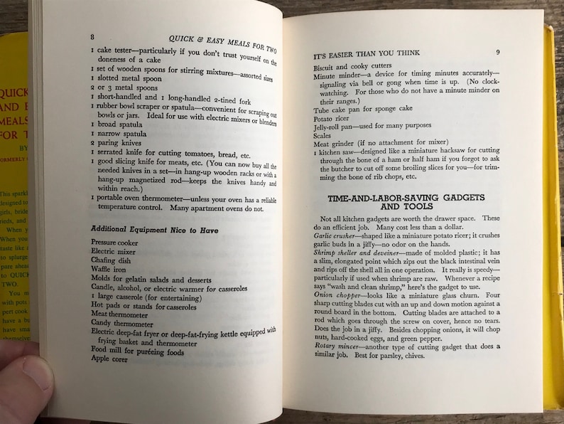 May include: A page from a vintage cookbook with a yellow background and black text. The page lists kitchen tools and gadgets, including a pressure cooker, electric mixer, chafing dish, waffle iron, molds for gelatin salads and desserts, a candle warmer, a large casserole, hot pads, a meat thermometer, a candy thermometer, an electric deep-fat fryer, a food mill, and an apple corer.