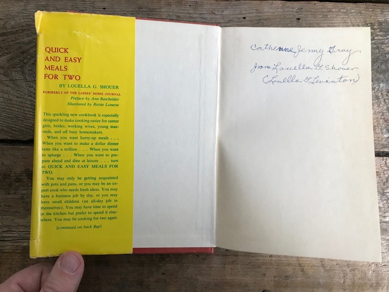 May include: A yellow and green cookbook titled "Quick and Easy Meals for Two" by Louella G. Shouer. The book is open to the first page, which includes a preface by Ann Batchelder and illustrations by Reisie Lonette. The book is designed to make cooking easier for busy people.