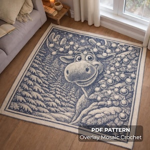 May include: A blue and white mosaic crochet rug featuring a cartoon moose with Christmas lights on its antlers and a decorated Christmas tree. The rug has a border and the text "PDF PATTERN Overlay Mosaic Crochet".
