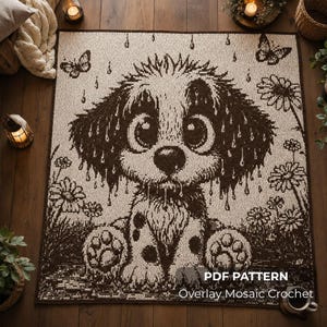 Op de afbeelding: Een rechthoekige gehaakte deken met een donkerbruin en crèmekleurig mozaïekpatroon van een puppy die in de regen zit tussen bloemen en vlinders. Rechtsonder staat de witte tekst PDF PATTERN Overlay Mosaic Crochet.