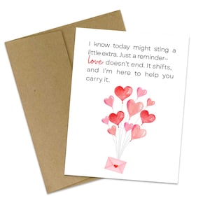 May include: A greeting card with a brown envelope. The card has a white background with the text "I know today might sting a little extra. Just a reminder- love doesn't end. It shifts, and I'm here to help you carry it." and a heart balloon design.