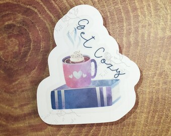 Get Cozy : sticker; available in clear, vinyl, holographic, & thick paper varieties