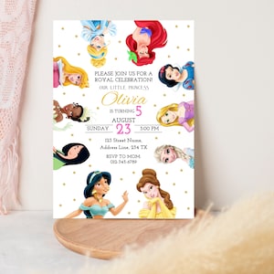 May include: A white invitation with gold stars and a pink and white border. The invitation features a collage of Disney princesses, including Cinderella, Ariel, Snow White, Tiana, Rapunzel, Elsa, Jasmine, and Belle. The text reads "Please join us for a Royal Celebration! Our little princess Olivia is turning 5 August 23, 3:00 PM. 123 Street Name, Address Line, 234 TX. RSVP to Mom 012-345-6789."