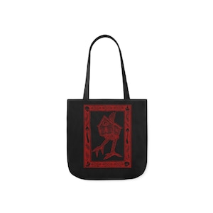 May include: Black tote bag with red trim featuring a red illustration of a house with legs and eyes, surrounded by a red frame with various symbols.