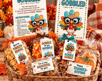 May include: A woven basket filled with clear treat bags containing popcorn, candy corn, chocolates, and pumpkin cookies. Each bag has a tag with Thanksgiving text and turkey graphics. Two large instruction cards read You've been GOBBLED.