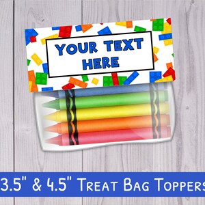 May include: A printable treat bag topper featuring a colorful Lego brick pattern with the text "YOUR TEXT HERE" in a blue box. The topper is 3.5 inches by 4.5 inches and includes a clear plastic bag with crayons.