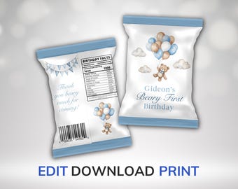 May include: Two white party favor bags with blue trim. One bag features text and a banner, the other has a teddy bear with balloons. The bags are for Gideon's first birthday. The text says "Thank you beary much for coming!"