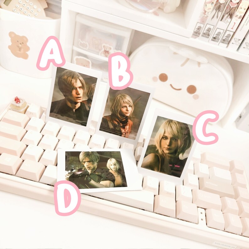 May include: Four white photo frames with black borders, each featuring a different character from a video game. The frames are arranged on a white keyboard with pink keys.