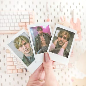 May include: Three instant photos of men. The first photo shows a man with short brown hair wearing a black leather jacket and a white t-shirt. The second photo shows a man with short brown hair wearing a black shirt. The third photo shows a man with short brown hair wearing a light blue shirt.
