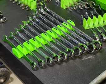 May include: A set of wrenches organized in a drawer with green plastic holders. Each wrench is labeled with its size in millimeters, ranging from 10mm to 19mm.