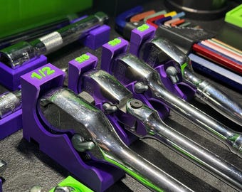 May include: Purple and green tool holders with a set of wrenches. The wrenches are labeled 1/2, 3/8, and 1/4.