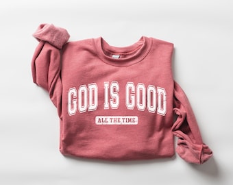 May include: A red sweatshirt with the text "GOD IS GOOD ALL THE TIME" in white.