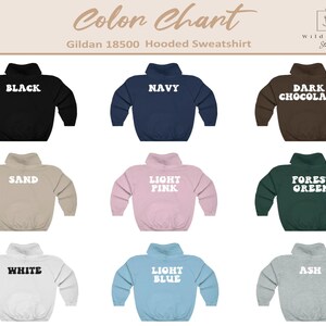 May include: Color chart showing ten different colors of Gildan 18500 hooded sweatshirts. The colors are black, navy, dark chocolate, sand, light pink, forest green, white, light blue, and ash.