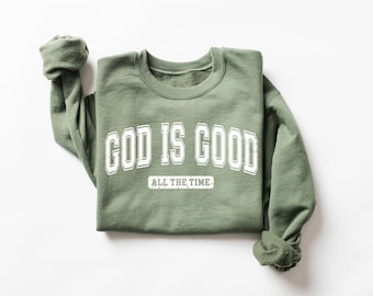 May include: A green sweatshirt with the text "GOD IS GOOD ALL THE TIME" in white.