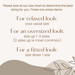 May include: Text on a white background with brown text explaining how to size unisex clothing for a relaxed, oversized, or fitted look.