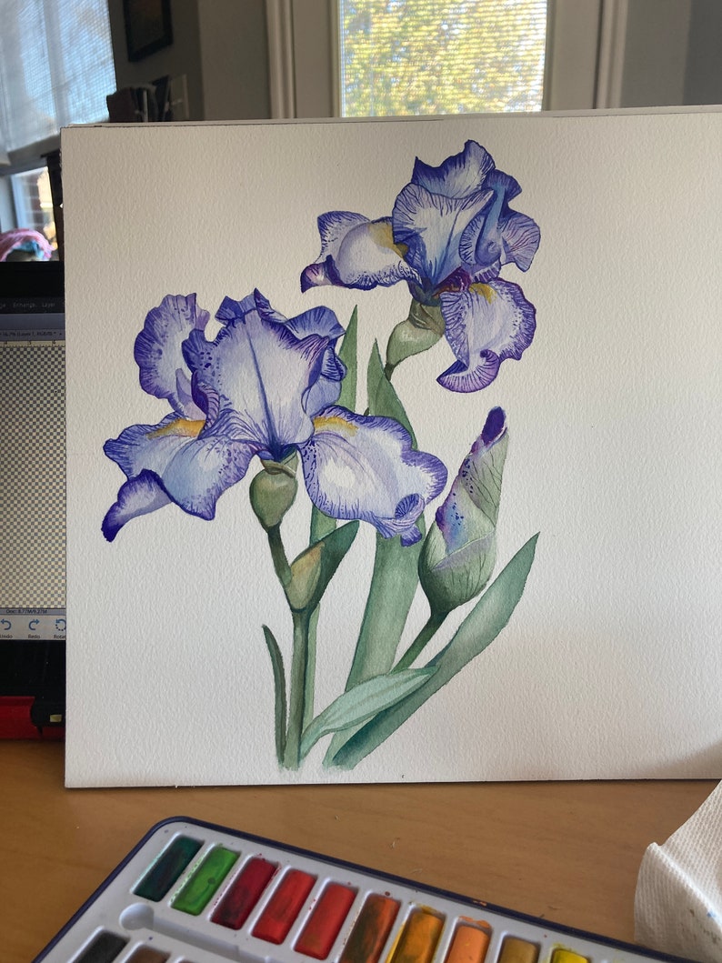 May include: Watercolor painting of purple iris flowers with green leaves and buds on a white background.