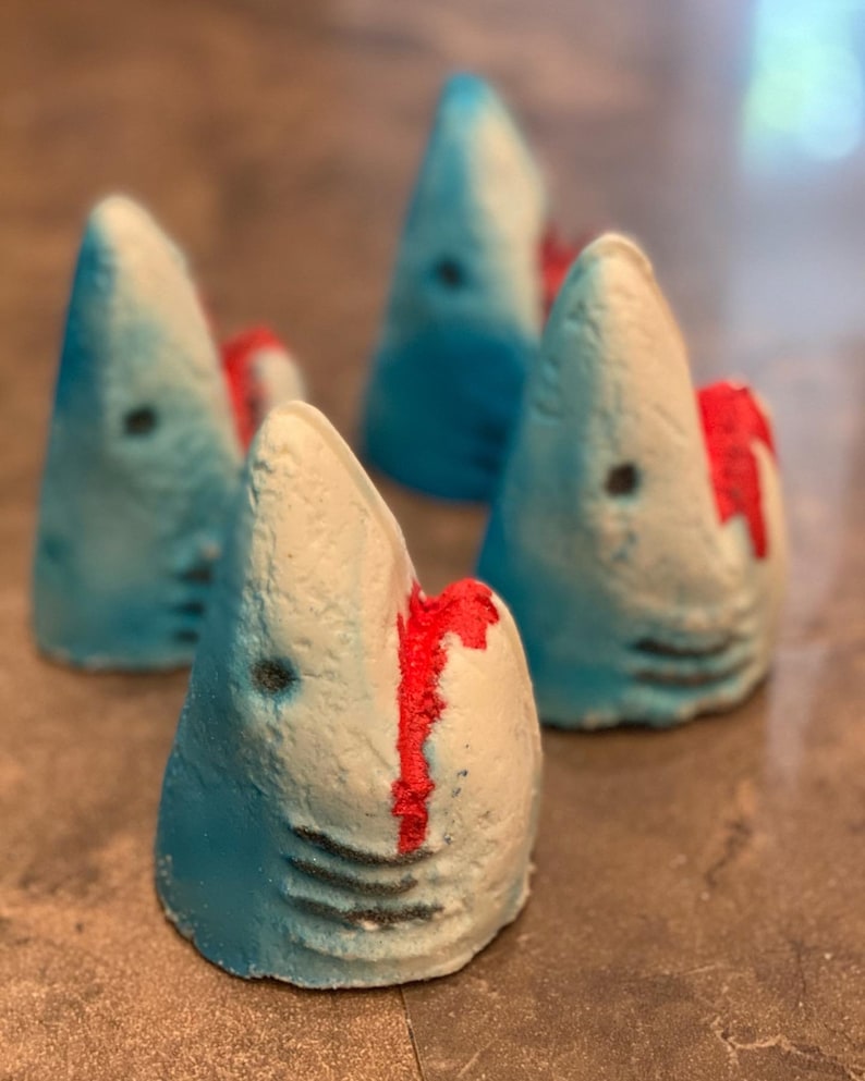 Large shark bath bomb comes with a shark charm inside the bath bomb. The bath bomb will also turn your bath water bloody red, simulating a shark attack!
