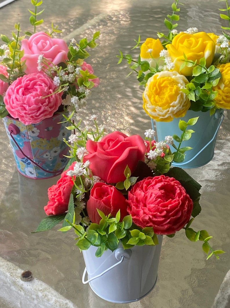 Soap roses, peonies, and tulips in an arrangement of artificial Baby’s breath and greeneries.