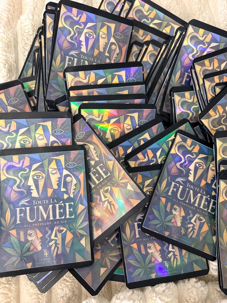May include: A collection of rectangular holographic pouches featuring a cubist-style illustration of faces, cannabis leaves, and the text "TOUTE LA FUM&Eacute;E" and "ALL PRESSURE, NO AIR" printed in a bold, dark font against a colorful, geometric background.