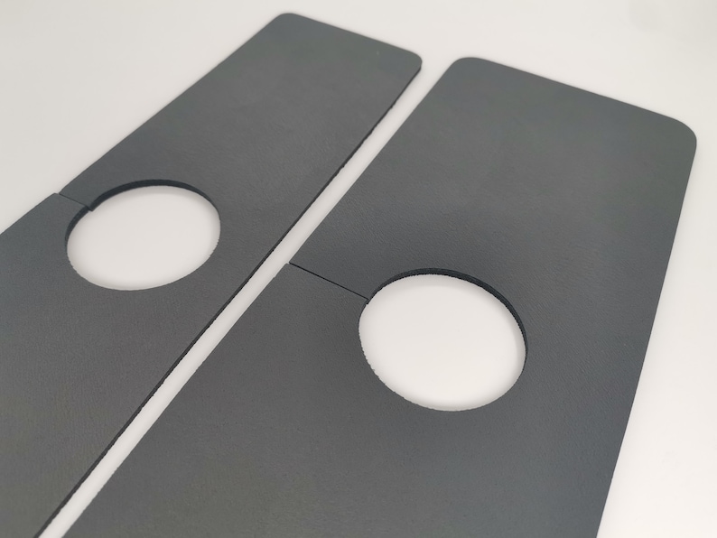 May include: Two gray cardboard pieces with cut-out circles. The pieces are designed to be joined together to create a larger shape.