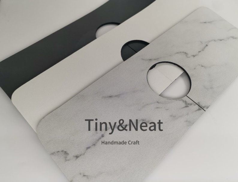 May include: Three white cardboard closet hanger dividers with a round hole in the center. The top divider has a marble pattern and the text "Tiny&Neat Handmade Craft".