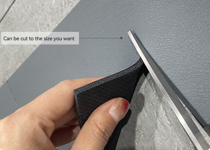 May include: A hand holds a black foam sheet with a pair of scissors cutting it. The text "Can be cut to the size you want" is visible in the image.