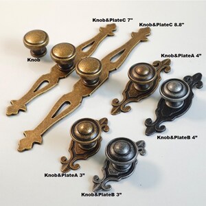May include: An assortment of antique-style cabinet knobs and pulls in various sizes and finishes. The hardware includes round knobs and pulls with decorative backplates. Sizes range from 3 to 8.8 inches. Finishes include bronze, brass, and pewter.