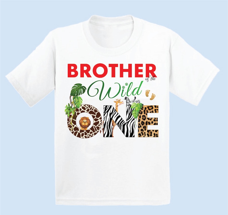 May include: White t-shirt with the text "BROTHER of the Wild ONE" in red and green. The word "ONE" is decorated with animal prints and illustrations of a lion, giraffe, and zebra. Includes small footprints.